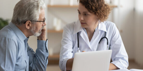 Young female professional doctor physician consulting old male patient