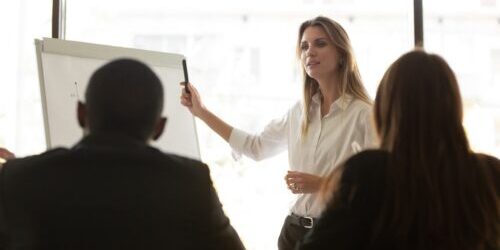 confident-female-speaker-making-whiteboard-presentation-to-employees.jpg?s=1024×1024&w=is&k=20&c=7cTIlsHTAlpspNgGczwh94dqP22n63uaBCSyHi9SueU=
