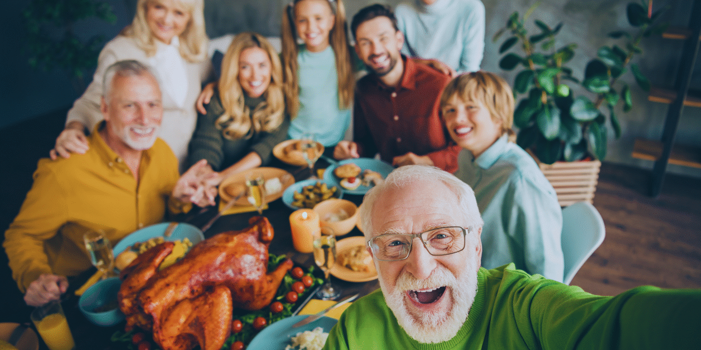 Untitled design (3) Smiling multigenerational family — grandparents, parents, and children with a dog — walking on a sunny beach, symbolizing snowbirds traveling with peace of mind and connected healthcare